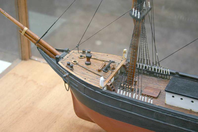 Wooden sailing ship in glass case