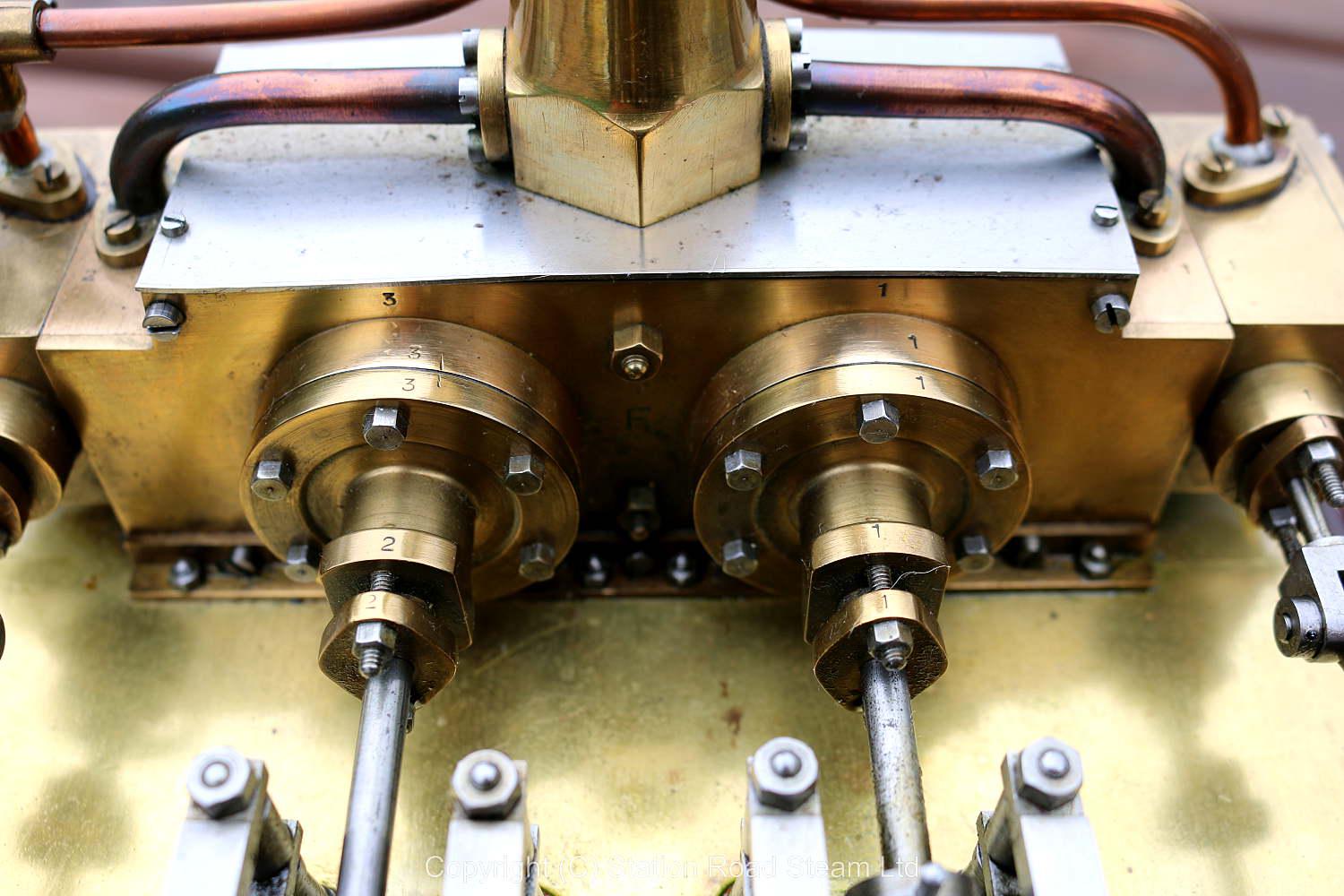 Horizontal twin mill engine on brass supports with hardwood base